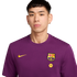 Headshot of a person with short dark hair wearing a purple Nike FC Barcelona t-shirt with the team crest and a Spotify logo, against a solid black background.