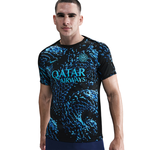 A man models a black Inter Milan football jersey with a vibrant teal and blue abstract pattern, featuring the Qatar Airways logo, against a white background.
