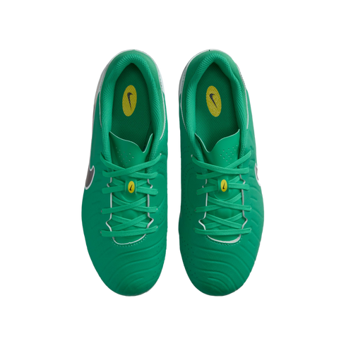 A top-down view of a pair of bright green Nike soccer cleats with matching laces and yellow brand logos on the tongue and insoles.
