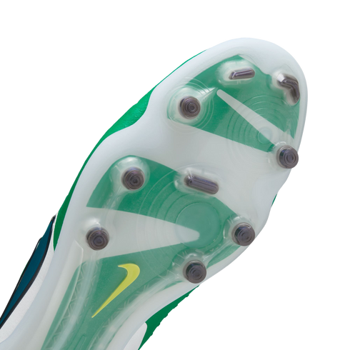 Close-up bottom view of a Nike soccer cleat featuring a translucent soleplate with green and white designs, metal-tipped studs, and a small yellow swoosh logo.