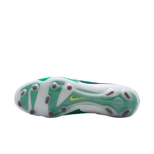 Outsole of a white and green Nike soccer cleat featuring translucent studs and a small yellow swoosh on a white background.