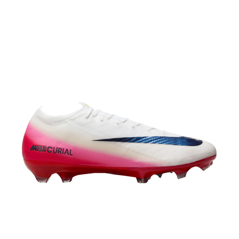 Side-profile of a white Nike Mercurial soccer cleat with a pink gradient, metallic blue swoosh, and red sole with studs, isolated on white.