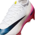 Close-up of a white Nike Mercurial soccer cleat featuring a pink gradient on the heel and a large black swoosh with a blue textured pattern.