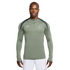 A man models a sage green Nike Chelsea FC quarter-zip training top with dark grey shoulder panels, pictured against a white background.