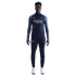 A man wearing a navy blue Nike PSG tracksuit with a Qatar Airways logo stands against a white background.