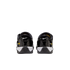 Rear view of black Nike Total 90 III sneakers with white midsoles and yellow branding against a white background.
