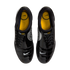 Top-down view of shiny black Nike Total 90 III soccer shoes with yellow insoles and small white swooshes on the toes, against a white background.