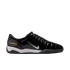 A side-profile view of a shiny black Nike Total 90 III indoor soccer shoe with a silver swoosh, white midsole, and black outsole.