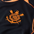 Close-up of the orange and black S.C. Corinthians Paulista crest embroidered on a black sports jersey.
