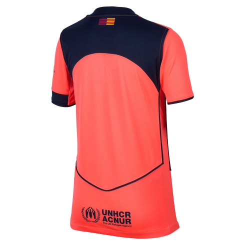 Back view of a coral sports jersey with a navy blue arched shoulder panel and sleeve cuffs. A UNHCR ACNUR logo is printed on the lower back.