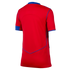 The back view of a short-sleeved red sports jersey with blue trim on the collar, sleeve ends, and a V-shaped seam detail on the lower back, shown against a black background.
