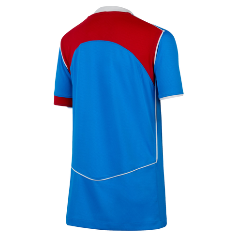Back view of a blue soccer jersey with a large red upper panel, white piping accents, and a white collar.