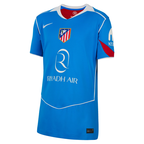 A bright blue Atlético Madrid soccer jersey by Nike featuring the Riyadh Air sponsor logo, white trim, and red accents in a classic Total 90 design.