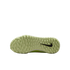 Underside of a pale green Nike shoe sole with small traction studs and a black swoosh logo, against a black background.