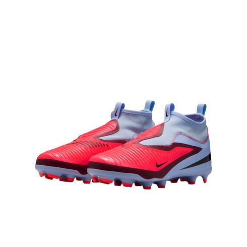 A pair of bright red and light blue Nike laceless football cleats with high-top sock collars, set against a black background.