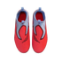 Top-down view of vibrant red and light blue Nike laceless soccer cleats on a black background.