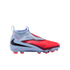 Profile of a light blue and bright red Nike laceless soccer cleat with a black swoosh, shown against a black background.