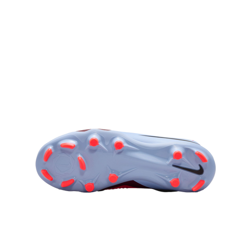 Bottom view of a light blue Nike soccer cleat with bright orange studs and a black Swoosh logo.
