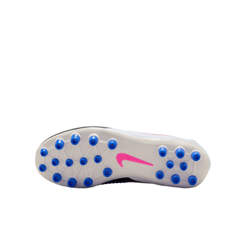 Sole of a Nike soccer cleat featuring multiple blue circular studs and a pink swoosh on a translucent white plate, shown against a black background.