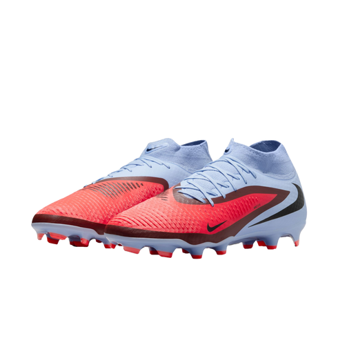 A pair of light blue and bright red Nike soccer cleats with high-top sock collars and textured uppers, set against a solid black background.