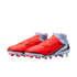 Nike soccer cleats with a bright orange forefoot, white heel, and integrated ankle sock. Features include black swooshes and firm-ground studs, shown against a black background.