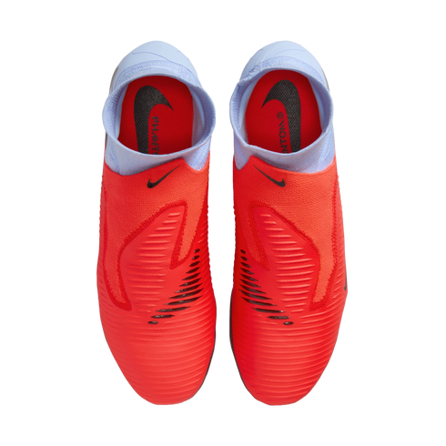 Top-down view of bright red Nike Phantom soccer cleats featuring light blue sock-like collars and black Nike logos, set against a solid black background.