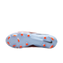 The light blue soleplate of a Nike soccer cleat featuring bright orange studs and a black swoosh on the heel, displayed against a black background.