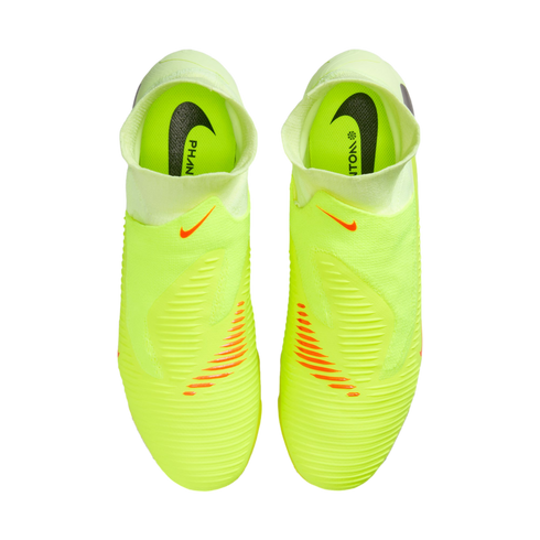 Top-down view of neon yellow Nike Phantom laceless soccer cleats on a black background, featuring orange accents and black Nike logos on the insoles.