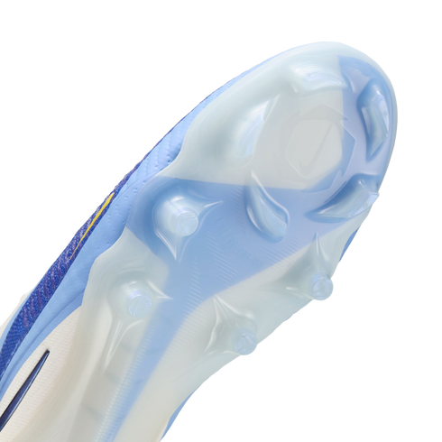 Close-up of the light blue and white soleplate of a Nike soccer cleat, showing translucent studs and a textured grip pattern.