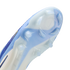 Close-up of the light blue and white soleplate of a Nike soccer cleat, showing translucent studs and a textured grip pattern.