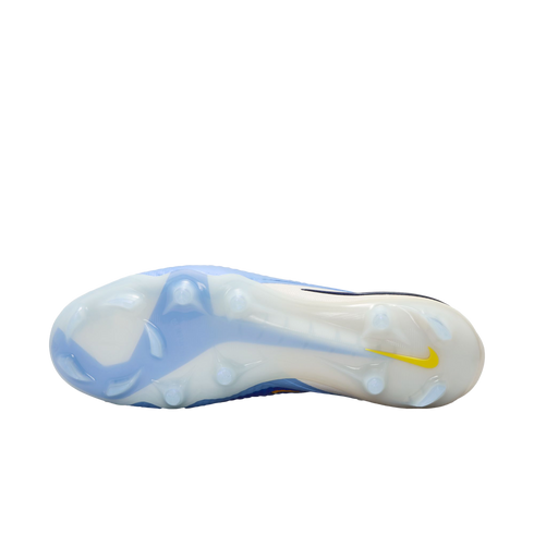 Bottom view of a light blue and white Nike soccer cleat with translucent studs and a small yellow swoosh on the heel.