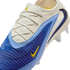 Close-up of a Nike Phantom soccer boot with a cream knit upper, textured blue panels, and a yellow swoosh logo.
