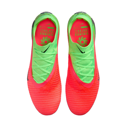 A top-down view of a pair of Nike soccer cleats featuring a vibrant neon orange and lime green color scheme. The shoes have a textured orange toe that transitions into a lime green heel with matching green laces. The interior is bright orange with green t