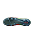 A bottom-up view of a Nike soccer cleat featuring an iridescent dark green soleplate with translucent studs. A small red Nike swoosh is visible near the heel, and the edges of the red and neon green upper are visible against a solid black background.
