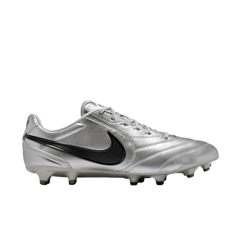 A side profile view of a metallic silver Nike soccer cleat with a black swoosh against a black background.