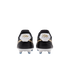 Rear view of black Nike soccer cleats with gold cursive branding on white heel tabs and white soleplates with blue studs against a black background.