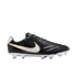 Profile view of a black leather Nike soccer cleat with a white and gold swoosh, white sole plate, and light blue studs, isolated on a black background.