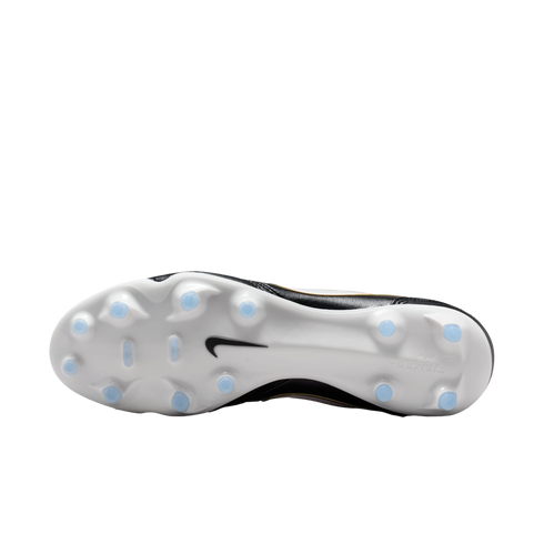 The white sole of a black Nike Tiempo soccer boot with light blue studs, shown against a black background.