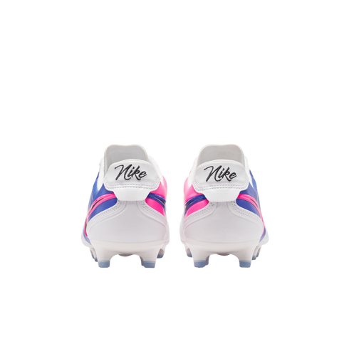 Rear view of white Nike soccer cleats with pink and blue accents and script branding on the heel, against a black background.