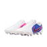 A pair of white Nike soccer cleats with blue heel sections and pink accents, featuring a black swoosh and white studs, against a black background.