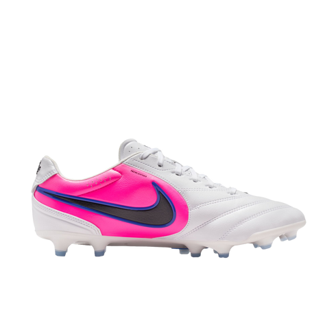 A white Nike soccer cleat with a vibrant pink heel panel and a dark grey swoosh outlined in blue, set against a black background.