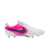 A white Nike soccer cleat with a vibrant pink heel panel and a dark grey swoosh outlined in blue, set against a black background.