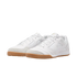 A pair of white Nike sneakers with tan gum soles and white laces, shown from a three-quarter angle against a solid black background.