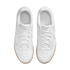 Top-down view of a pair of white Nike sneakers with gum soles, positioned against a solid black background.