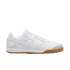 Profile of a white Nike indoor soccer shoe with a mesh and leather upper and a gum rubber outsole, set against a black background.