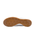 Underside of a gum rubber Nike shoe outsole with a hexagonal traction pattern against a solid black background.