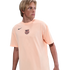 A young man with blond hair wearing a peach-colored FC Barcelona Nike t-shirt, looking to the side against a solid black background.