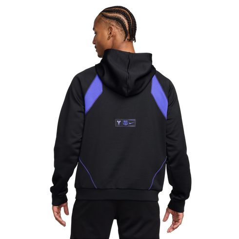 Back view of a person with braids wearing a black Nike hoodie with purple shoulder panels and small logos on the back.