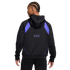 Back view of a person with braids wearing a black Nike hoodie with purple shoulder panels and small logos on the back.