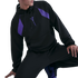 A person posing in a black Kobe Bryant x FC Barcelona hoodie with purple accents and matching black pants.